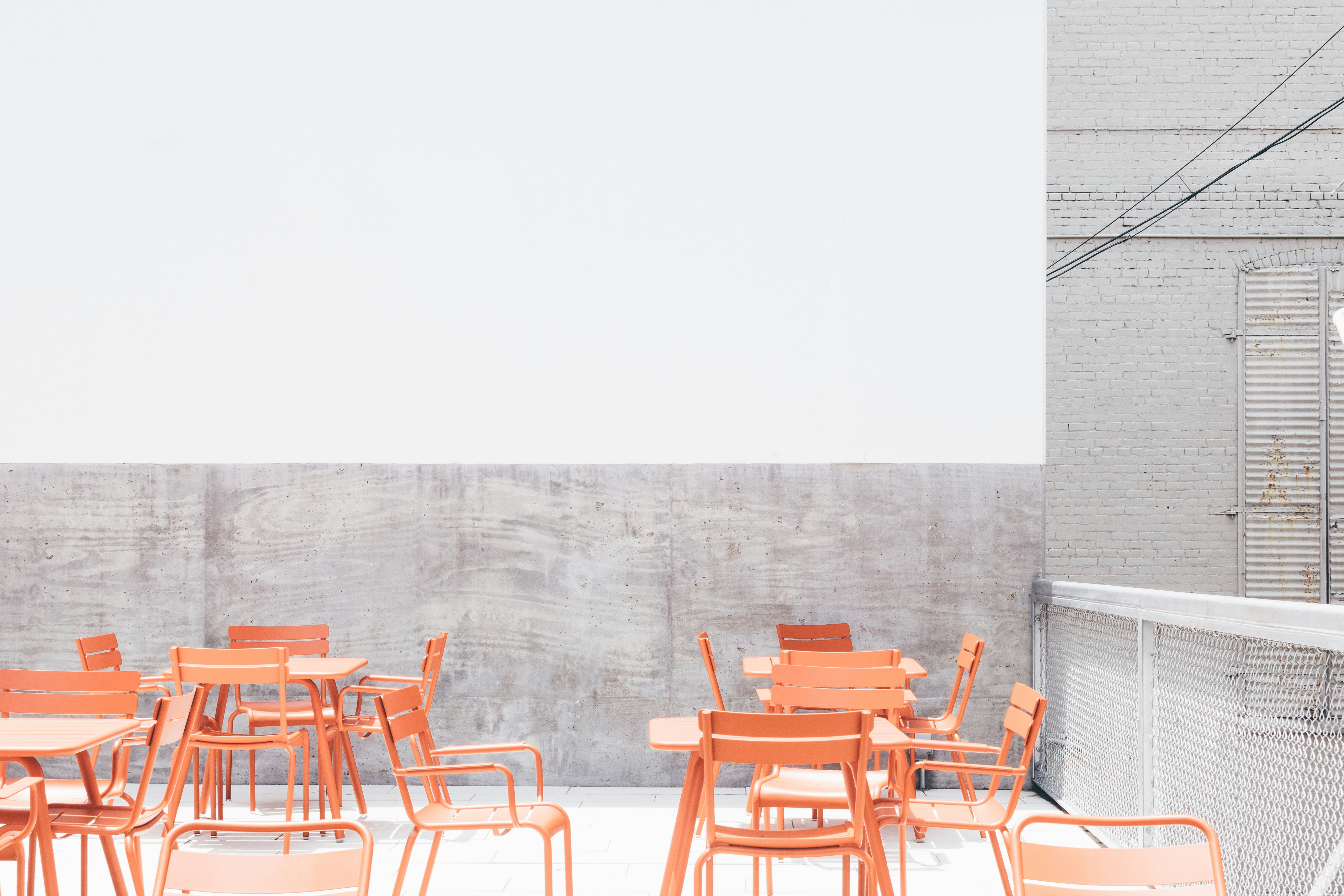 beige wooden table and chairs on rooftop during day